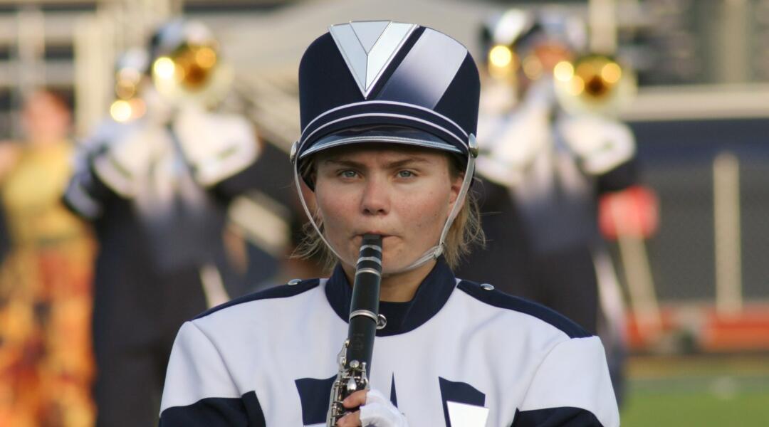 Marching band student playing clarinet