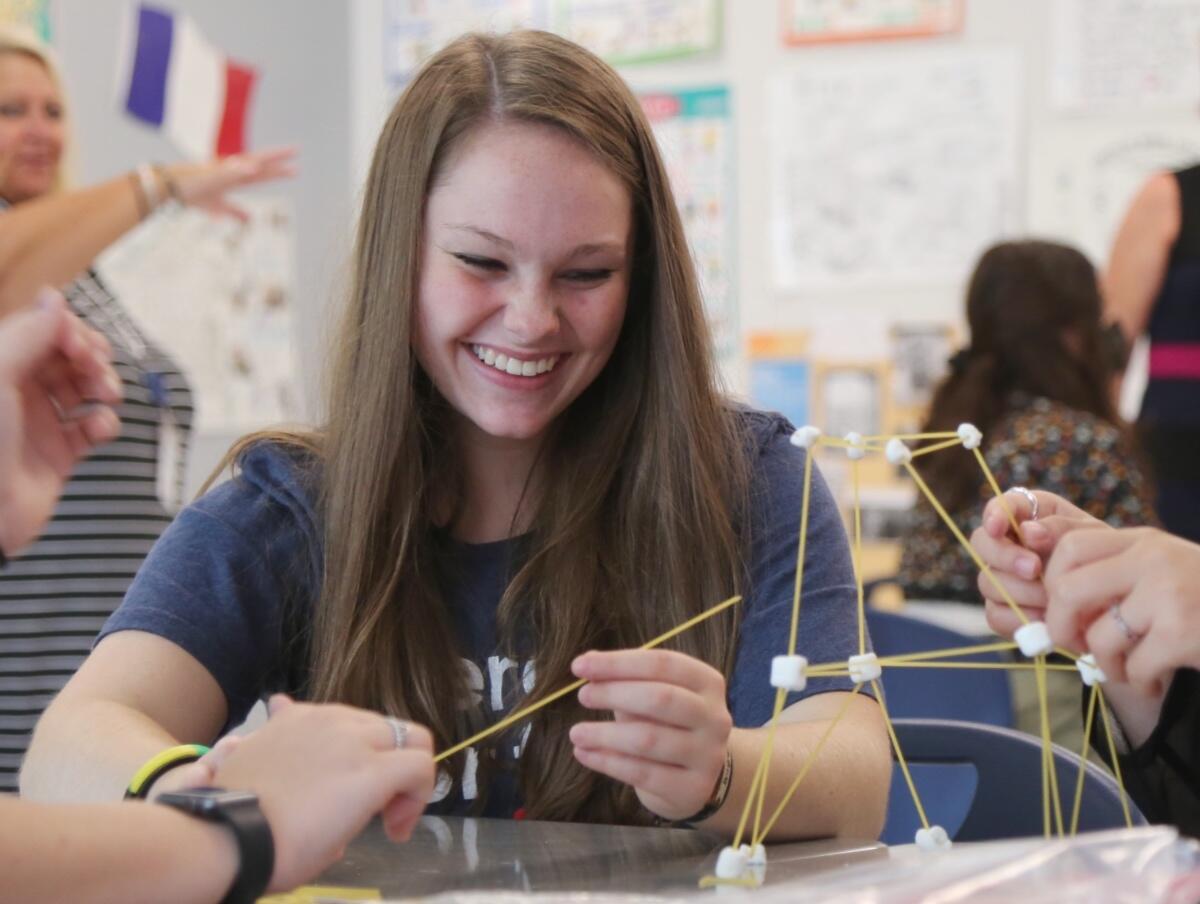 Student building objects out of spaghetti and marshmallows